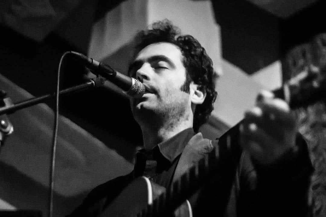 Black-and-white close-up of Ilko Birov singing at Villa Castelli